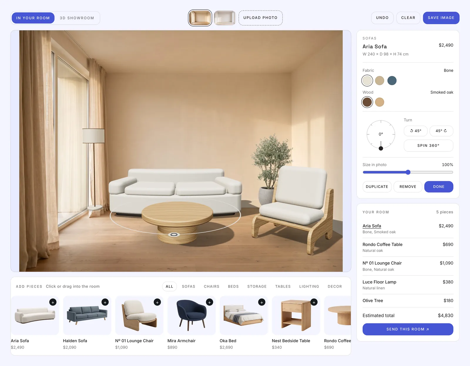 Roomkit on a store website: a living room photo with a sofa, coffee table, lounge chair and olive tree placed in it, the product library below and the room total on the right
