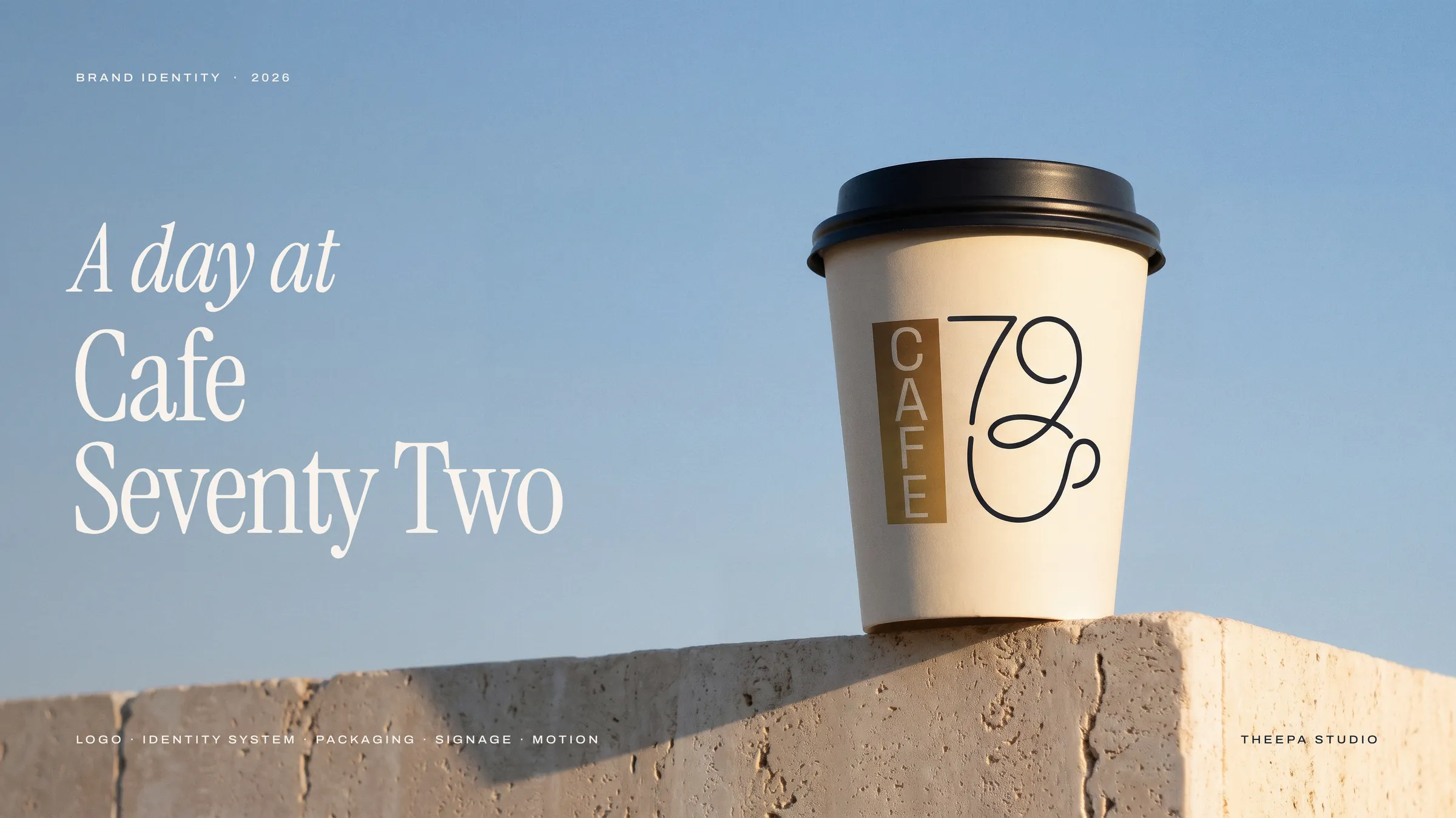 Cafe Seventy Two takeaway cup on travertine against a blue sky